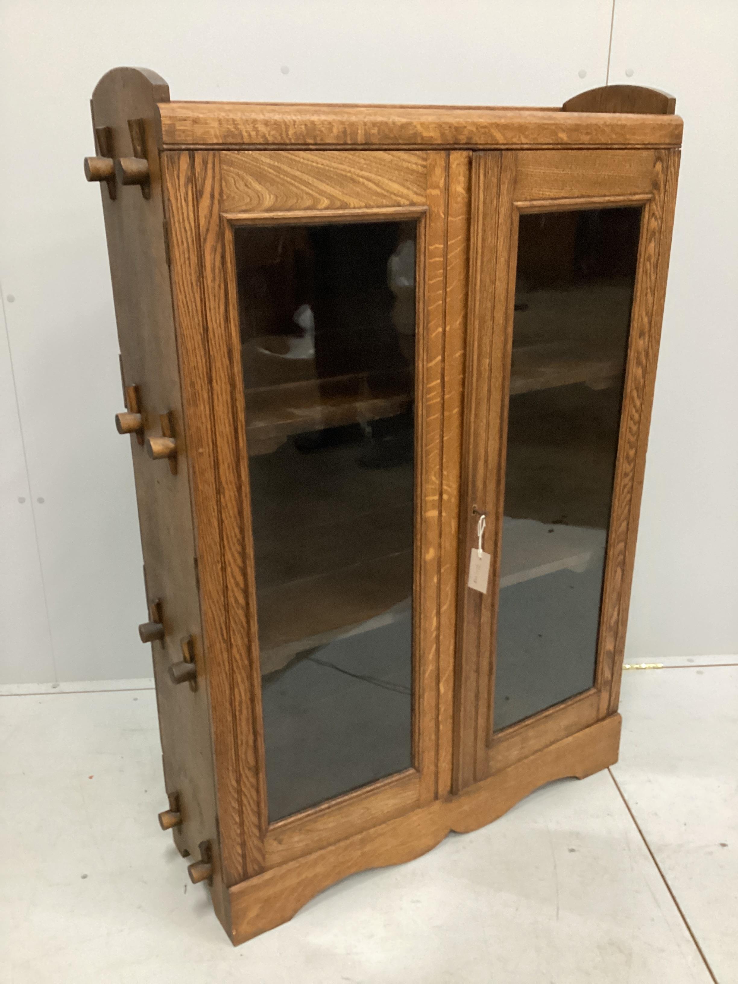 A Cotswold style glazed oak two door bookcase, width 90cm, depth 27cm, height 130cm